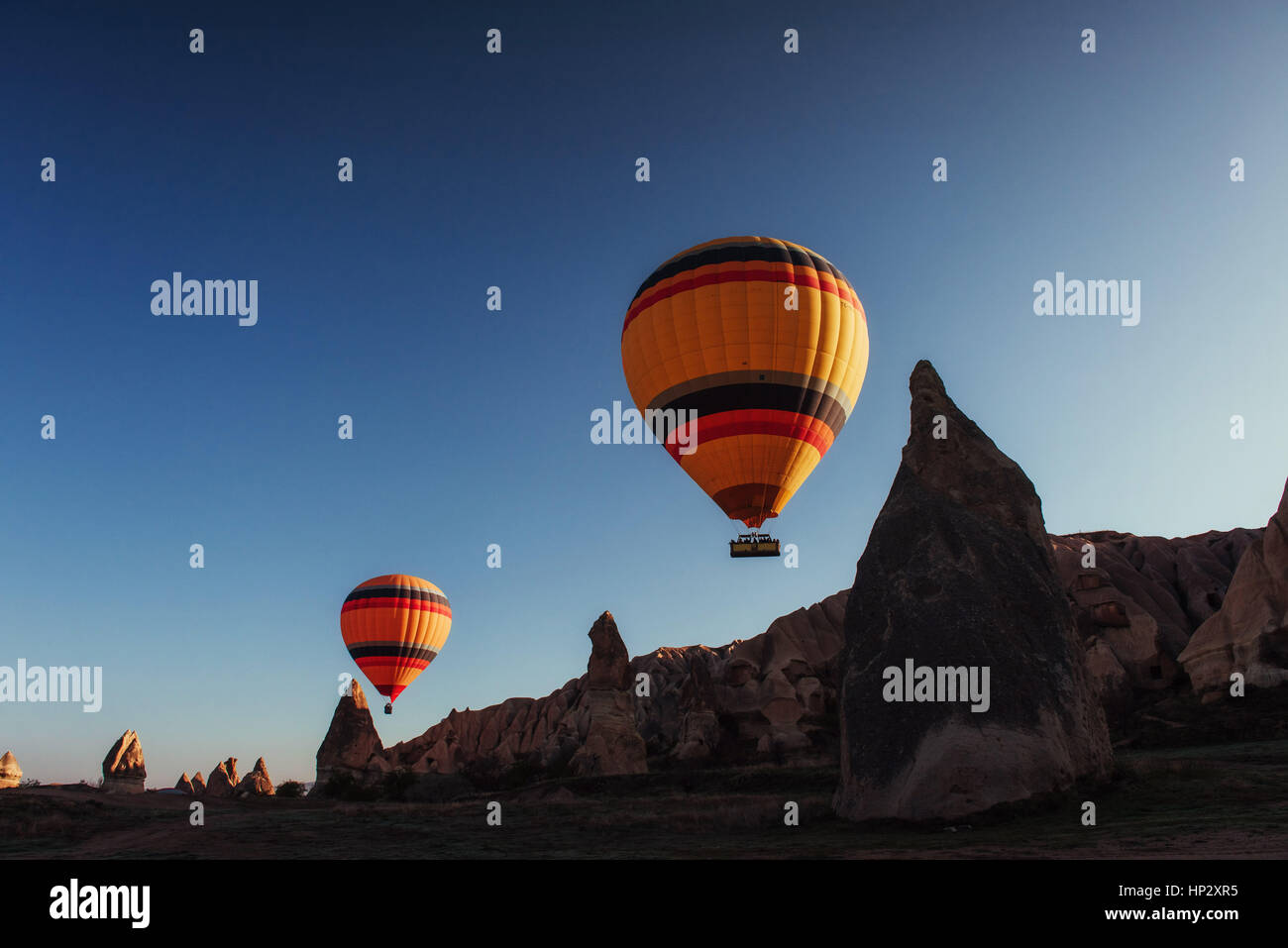 Hot air balloon flying over rock landscape at Cappadocia Turkey Stock ...