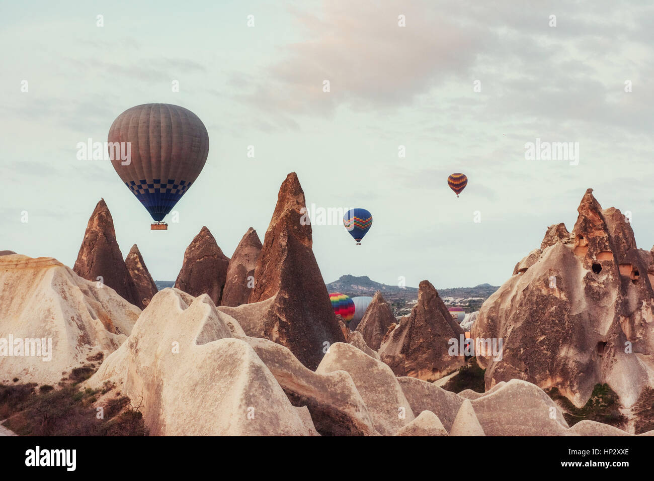 Hot air balloon flying over rock landscape at Cappadocia Turkey Stock ...