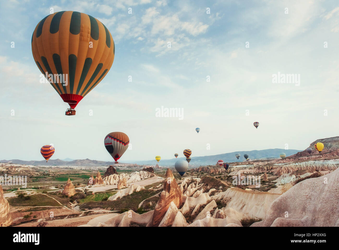 Hot air balloon flying over rock landscape at Cappadocia Turkey Stock ...