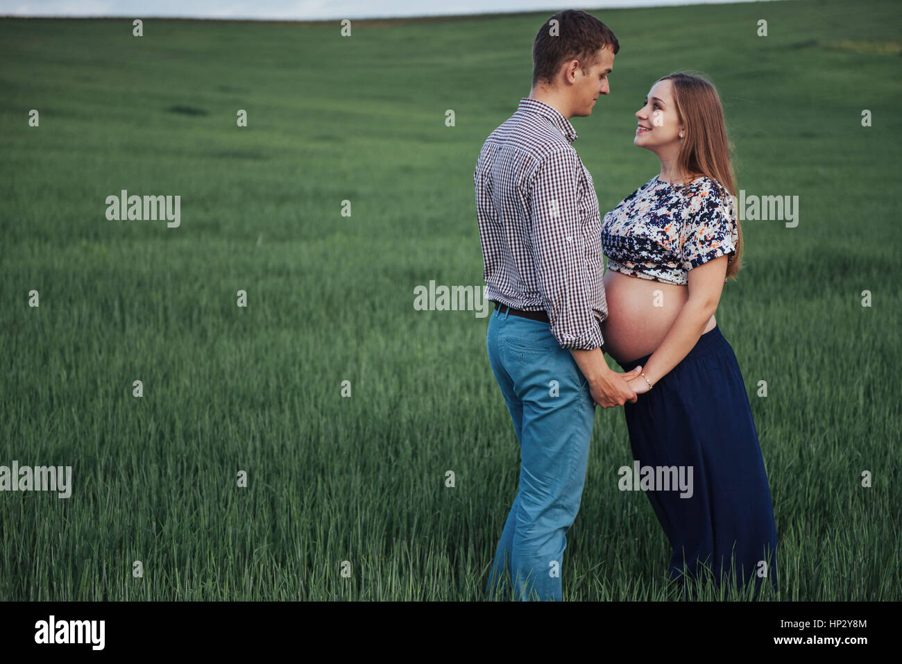 Happy couple awaiting baby. Beautiful and young parents Stock Photo - Alamy