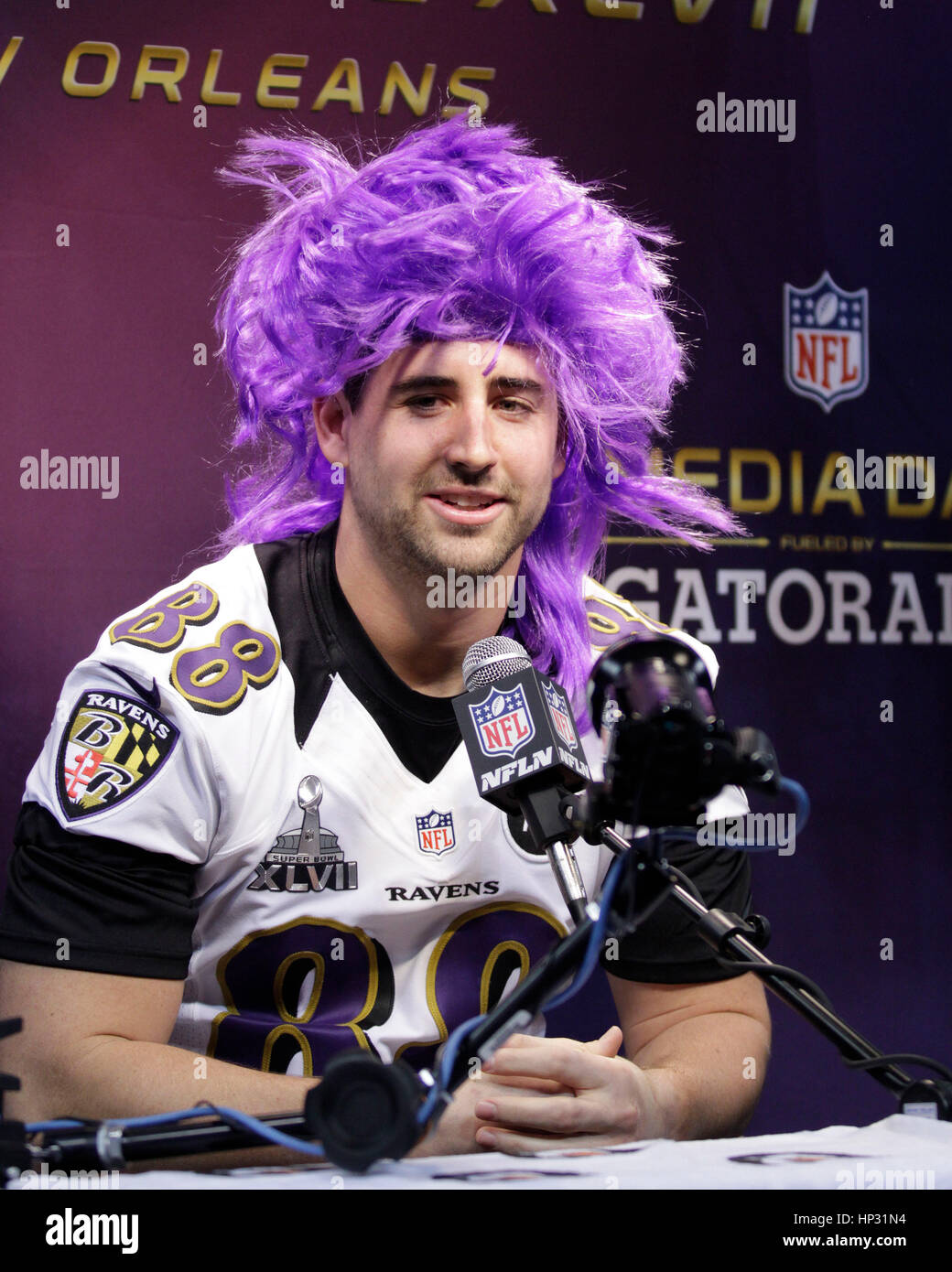 Baltimore Ravens Dennis Pitta wears a purple wig at the Super Bowl XLVII Media Day on January 29 