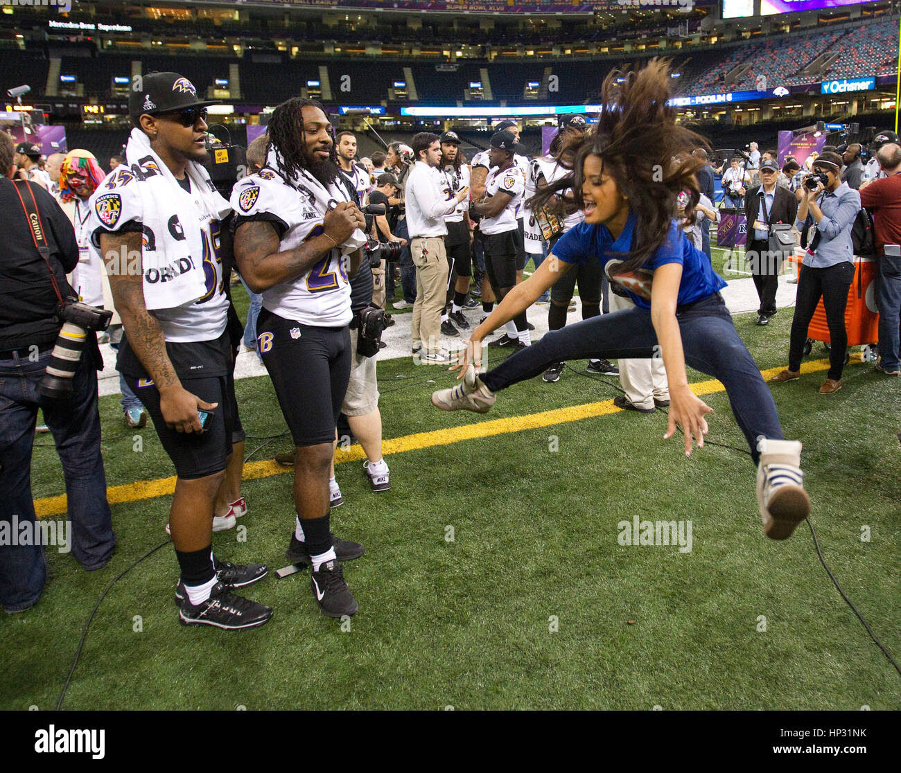 ET reporter Rocsi Diaz, right, jumps up to do a split with Baltimore ...