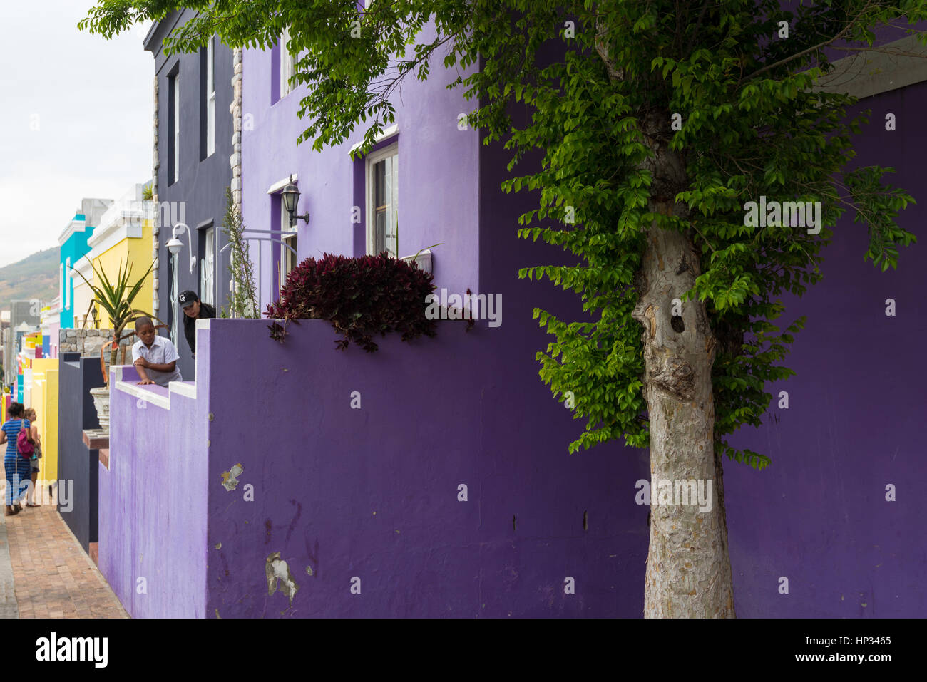Cape Town, South Africa - November 22, 2016: People in front of the colorful houses of the Bo-Kaap area in Cape Town, South Africa. Stock Photo
