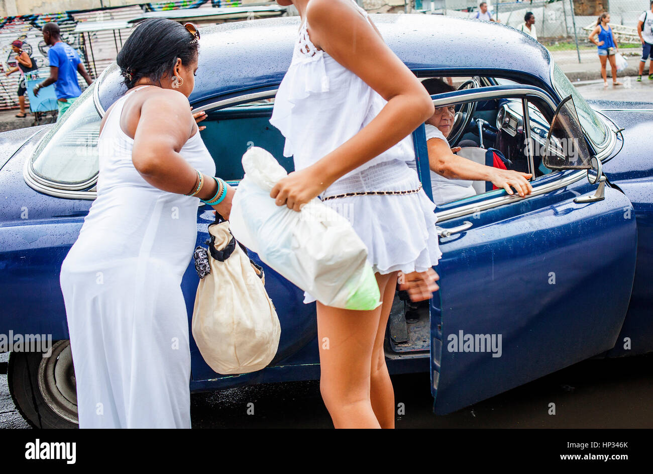 Women getting a taxi,in Dragones street, Centro Habana District, La Habana, Cuba Stock Photo