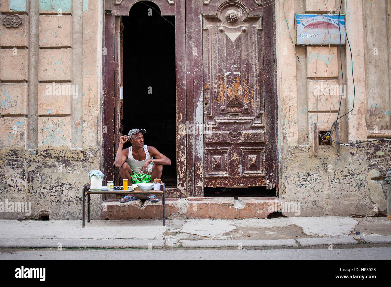 Man selling cigars and cafe, subsistence or survival shop,in Damas street, Habana Vieja district, La Habana, Cuba Stock Photo