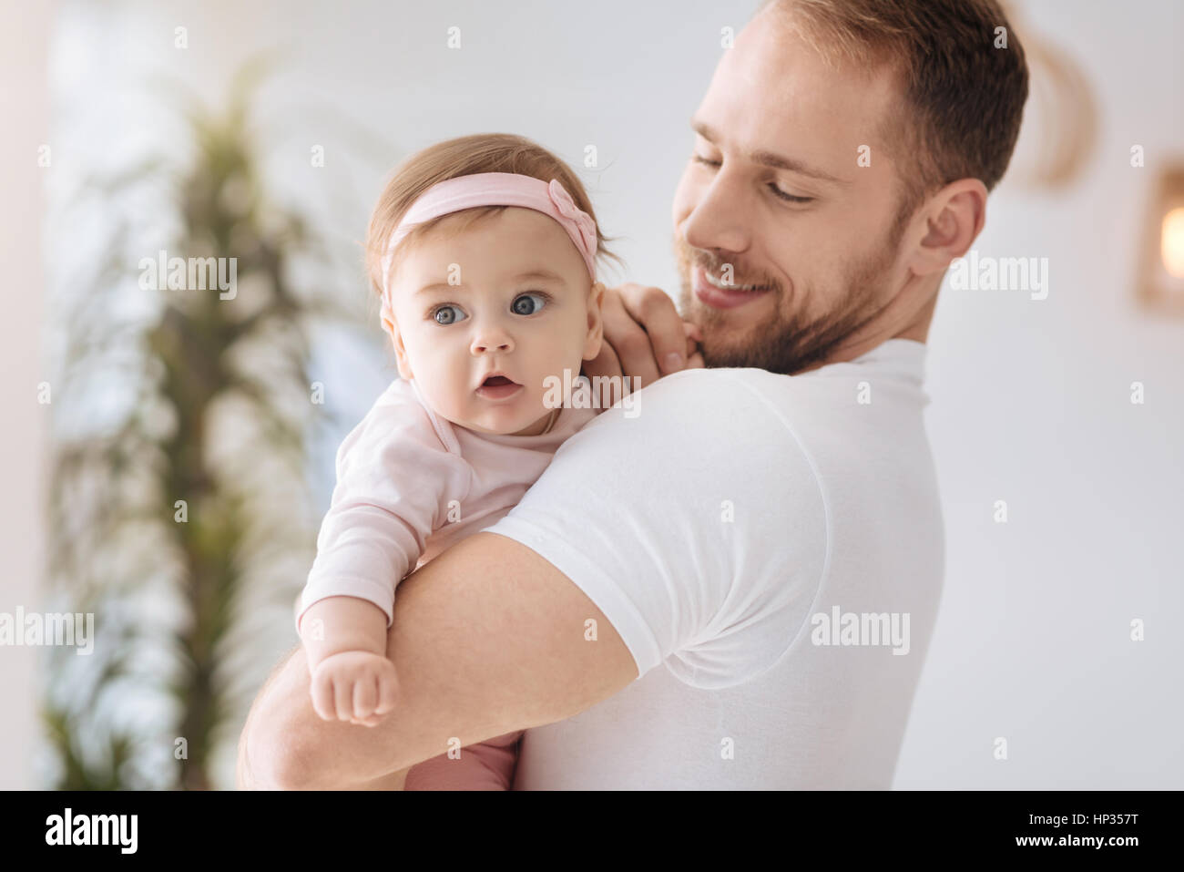 Curious kid in the arms of the father Stock Photo