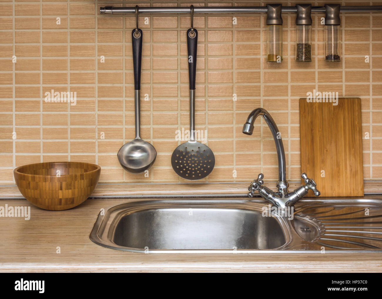 A part of an interior of home kitchen with utensils Stock Photo