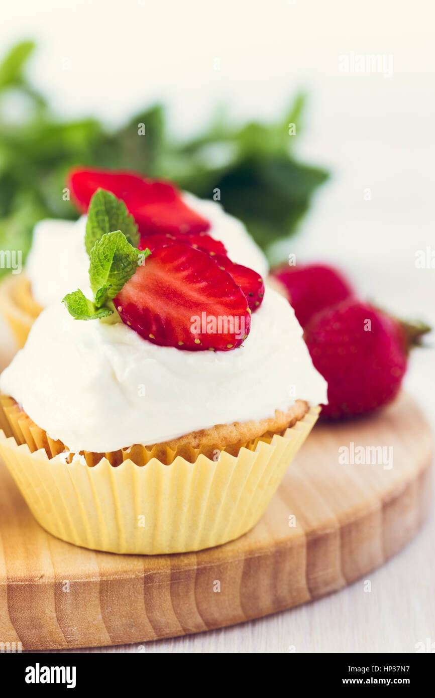 Homemade strawberry cupcakes with whipped cream topping Stock Photo Alamy