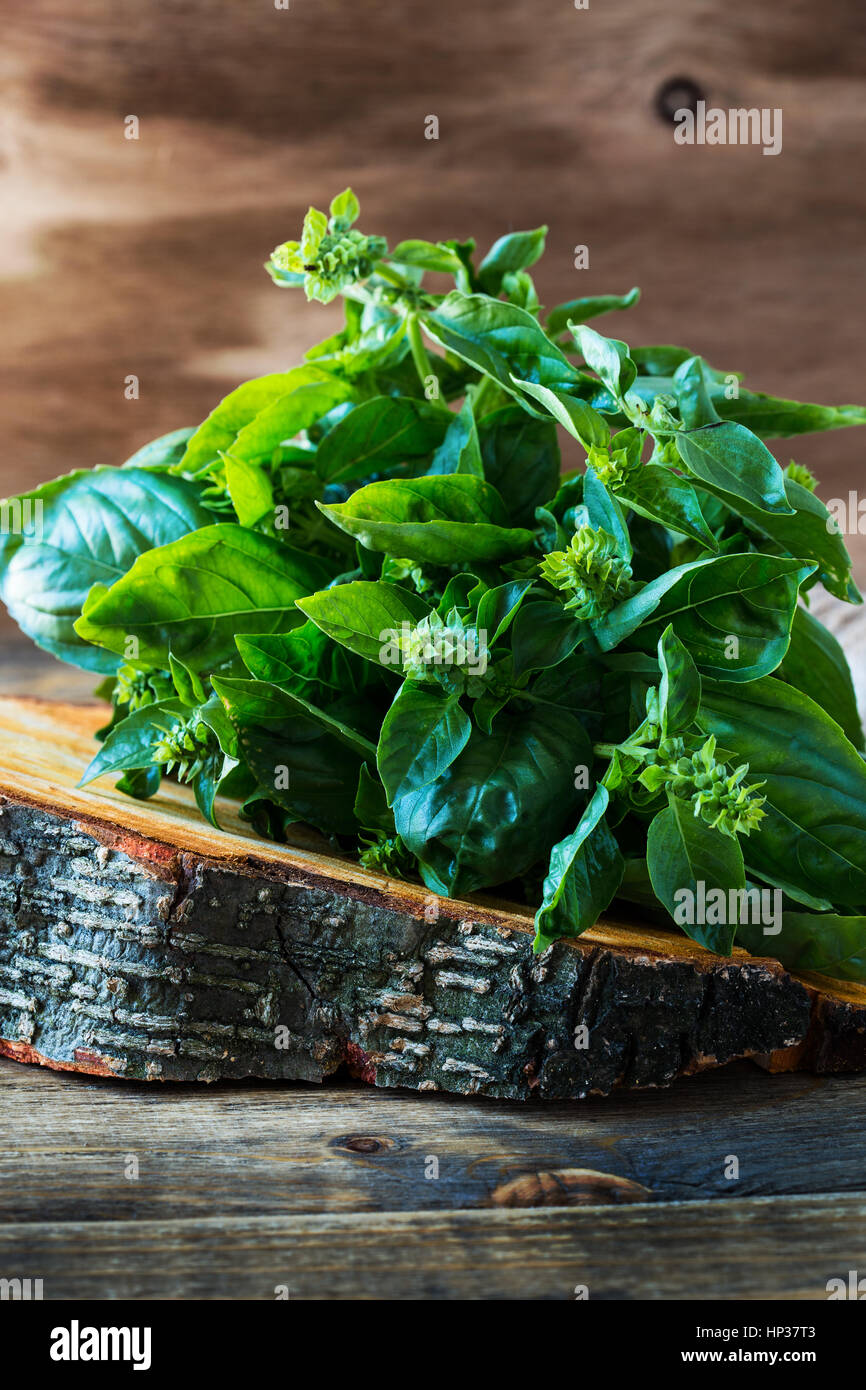 Fresh organic green basil leaves on rustic wood plank Stock Photo - Alamy