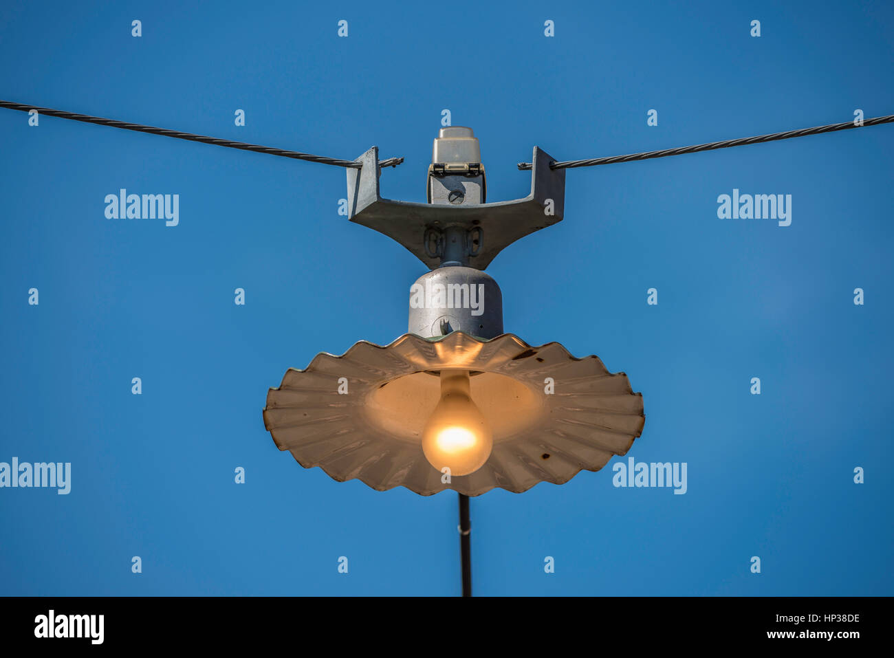 Suspended Outdoor Pendant Light against Blue Sky Stock Photo