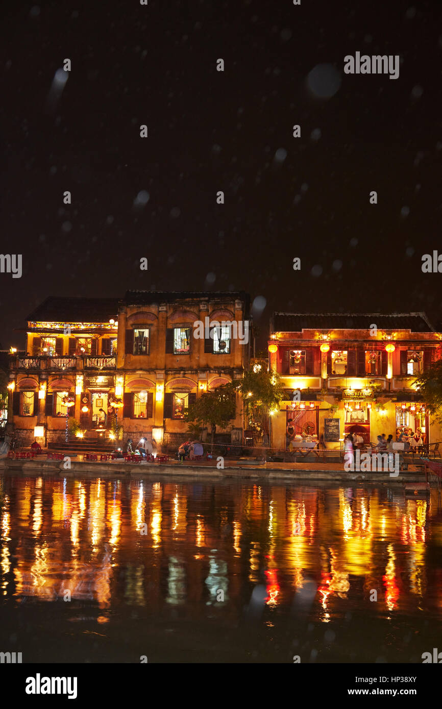 Rain and restaurants reflected in Thu Bon River at dusk, Hoi An (UNESCO World Heritage Site), Vietnam Stock Photo