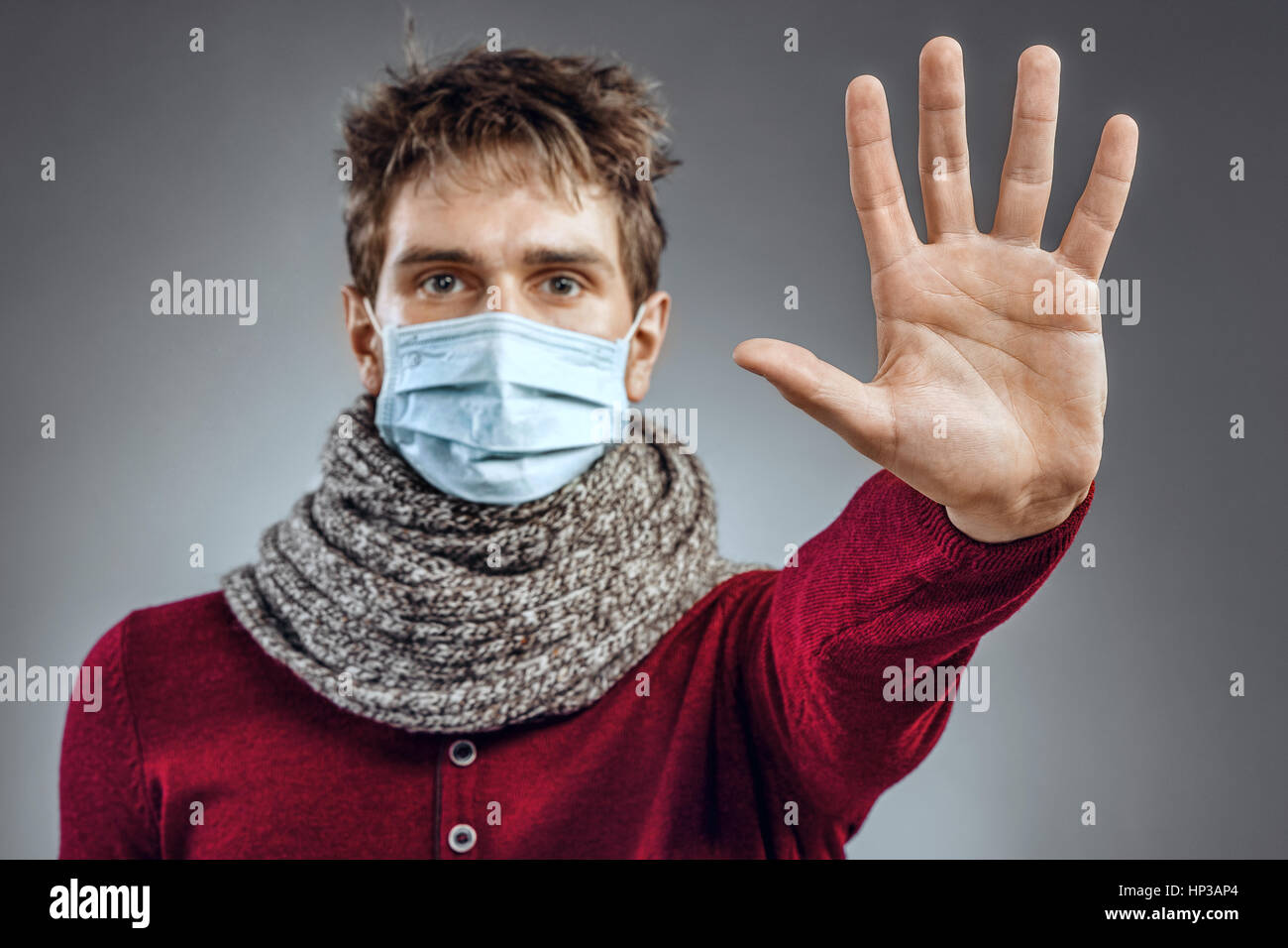 Stop - virus! Sick man in protective mask gesturing stop. Healthcare concept Stock Photo