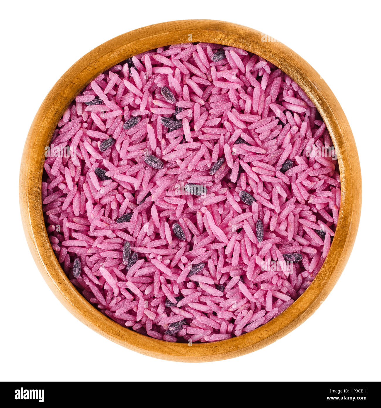 Glam Wedding Pink in a wooden bowl. Pink rice of lovers. Basmati and black rice colored with red beets, symbolizing crazy Bollywood weddings. Stock Photo