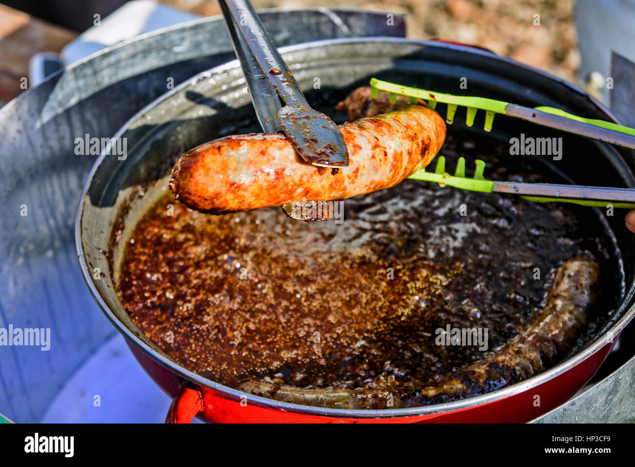 The traditional roast sausage in a special container in the open Stock