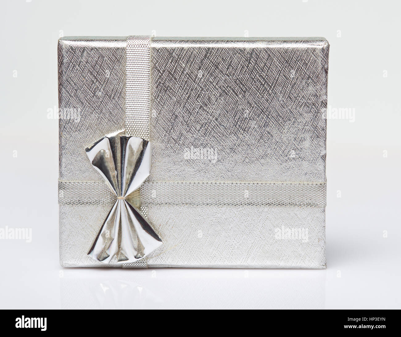 One silver gift box present isolated on white background view from top. Present silver box with ribbon Stock Photo