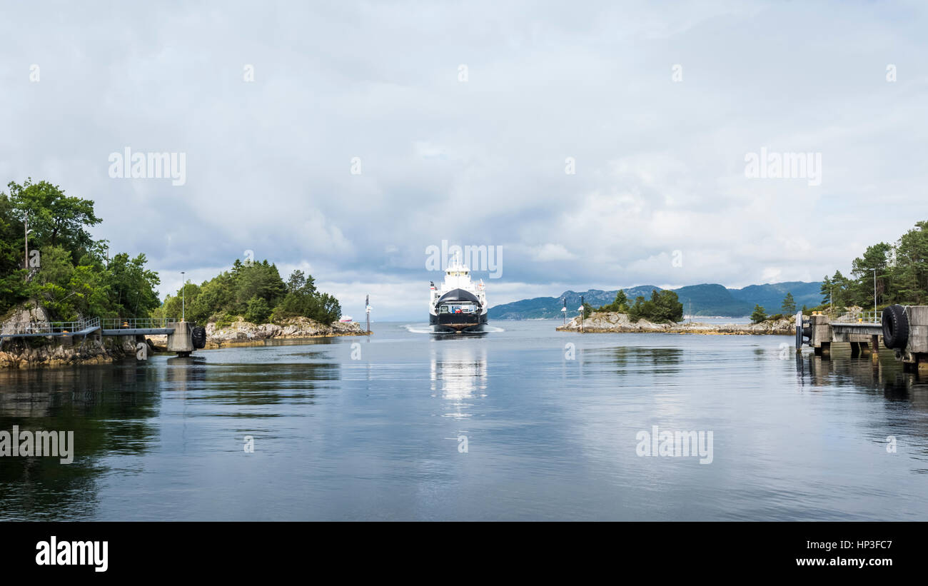 The ferry arriving from Scanvikvåg at the harbour of Halhjem - Norway. This is part of the national route E39. Stock Photo