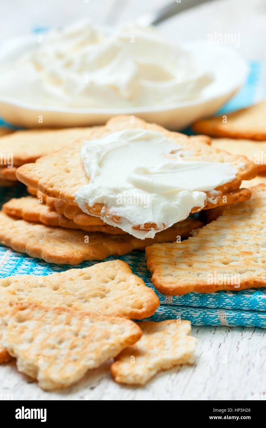light snack of crackers and cream cheese on blue napkin Stock Photo - Alamy