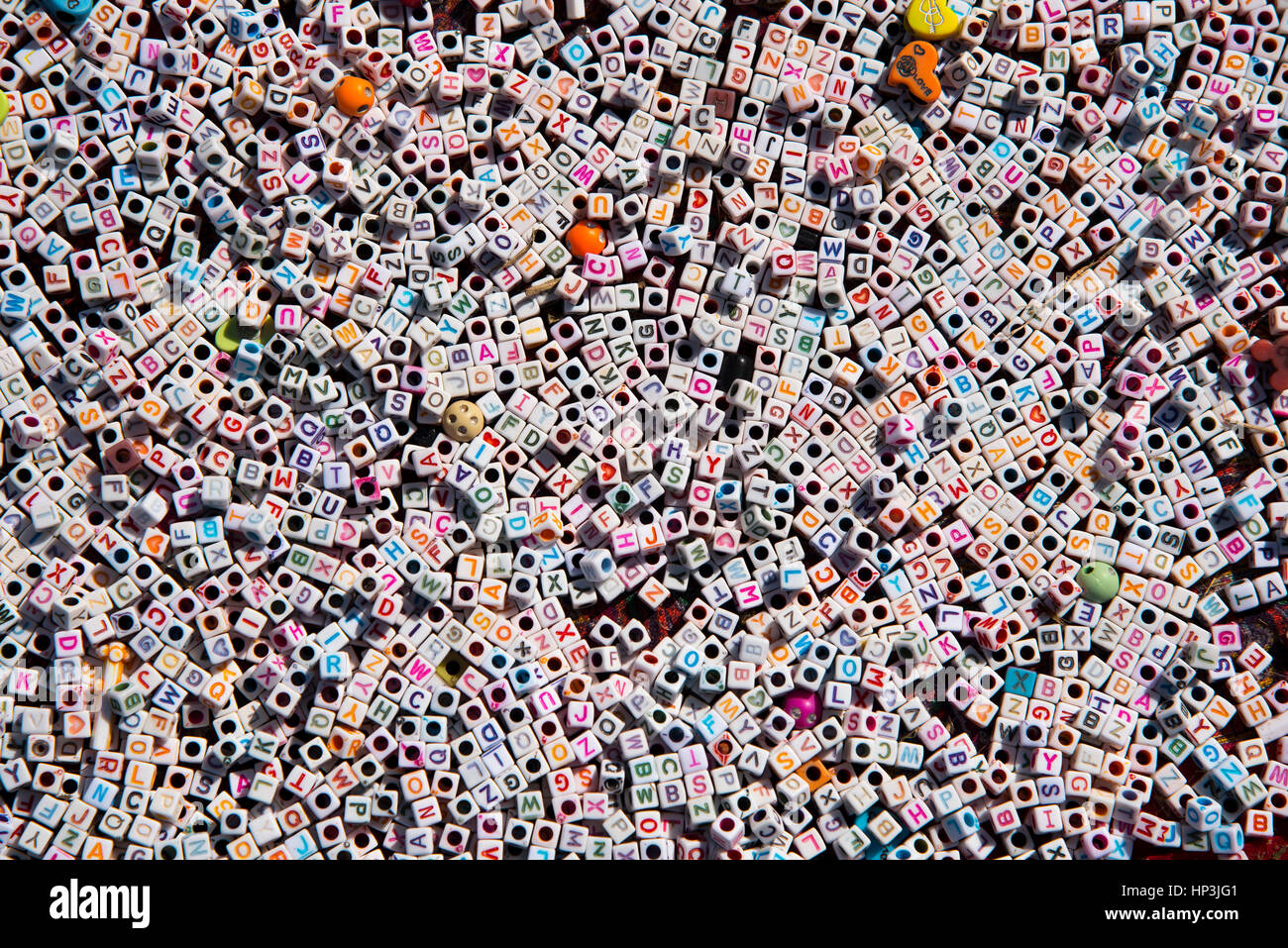 Multi-colored English alphabet beads background. Concept Image. Stock Photo