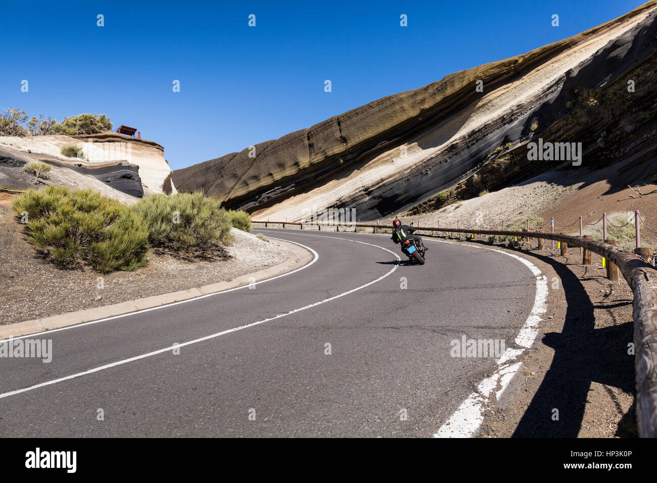 Motorcycle leaning over into a bend at the curva de la tarta on the road to the national park, las canadas del teide, tenerife, canary islands, spain Stock Photo