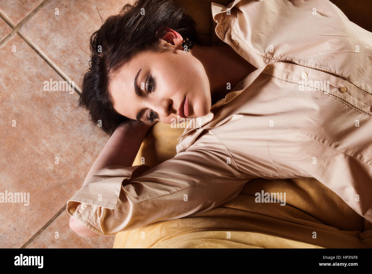 Young woman relaxing on couch in living room Stock Photo