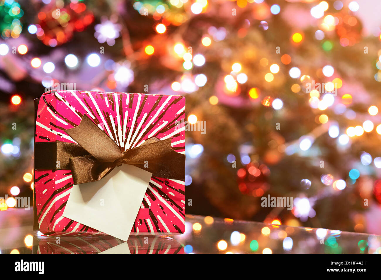 New year gift colourfull boxstand on glass table with blur background copy space Stock Photo