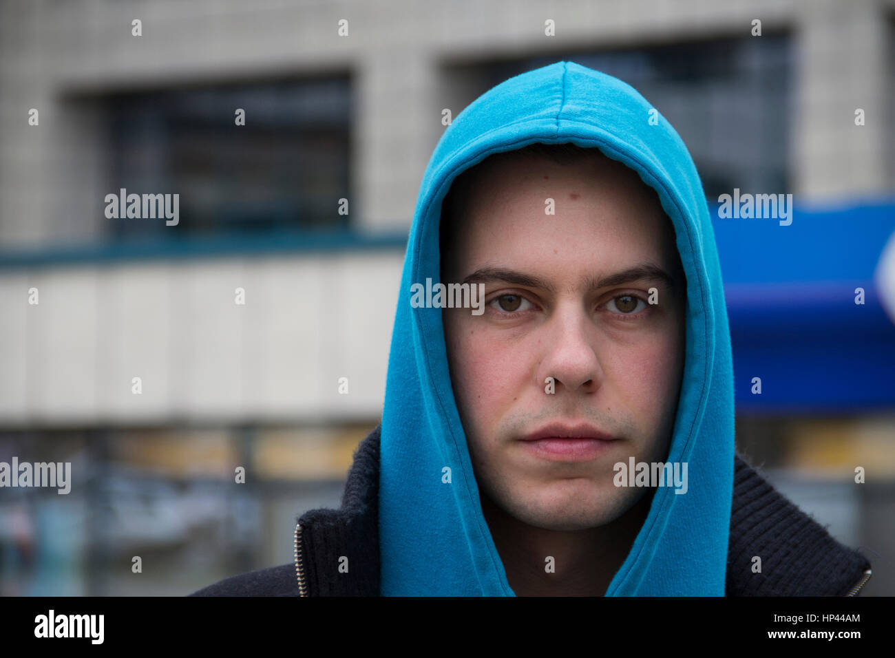 young man with a blue hood Stock Photo
