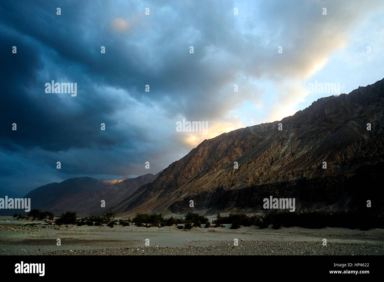 A landscape at evening in Nubra Valley, Ladakh, India with dramatic clouds and light play Stock Photo