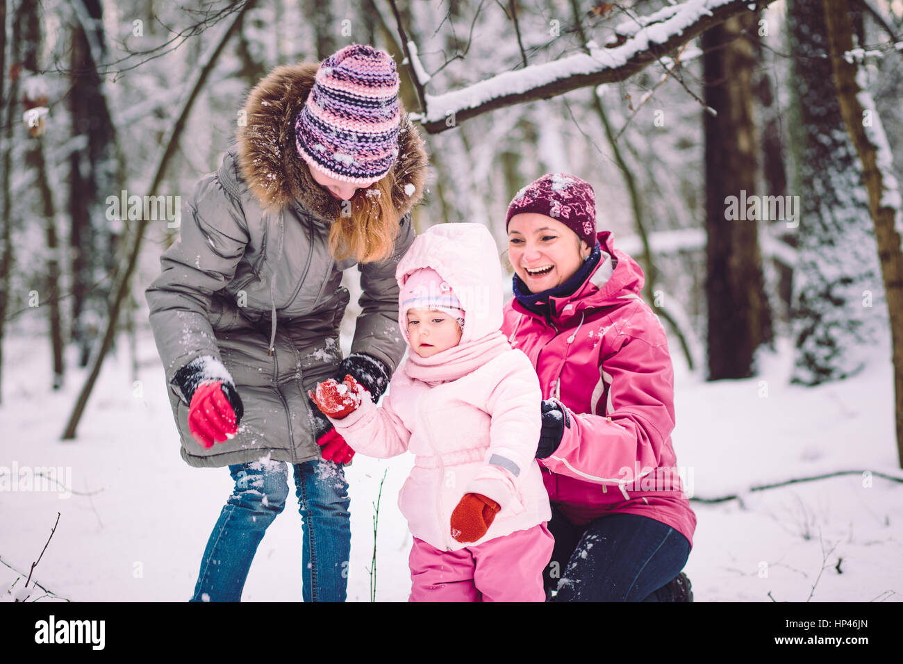 Mother spending time with her children outdoors in the wintertime Stock Photo