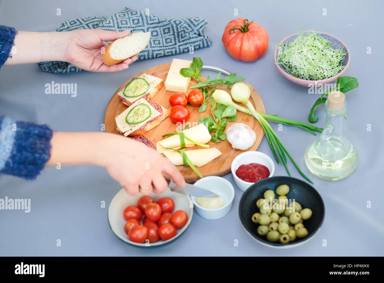 Preparing healthy snacks with fresh cheese and vegetables Stock Photo