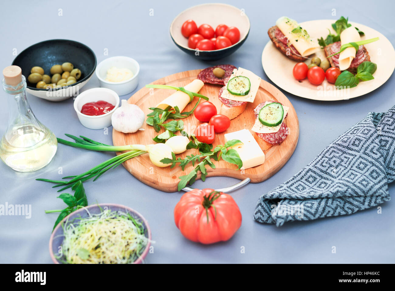 Preparing healthy snacks with fresh cheese and vegetables Stock Photo