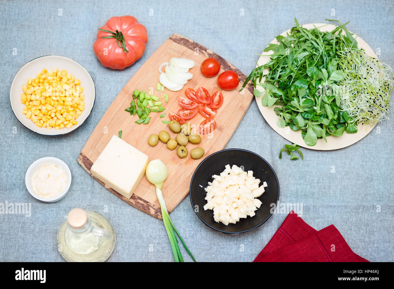 Preparing healthy snacks with fresh cheese and vegetables Stock Photo