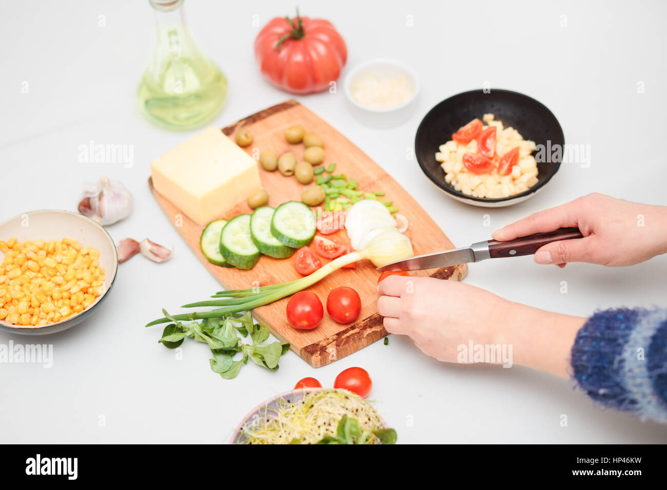 Preparing healthy snacks with fresh cheese and vegetables Stock Photo