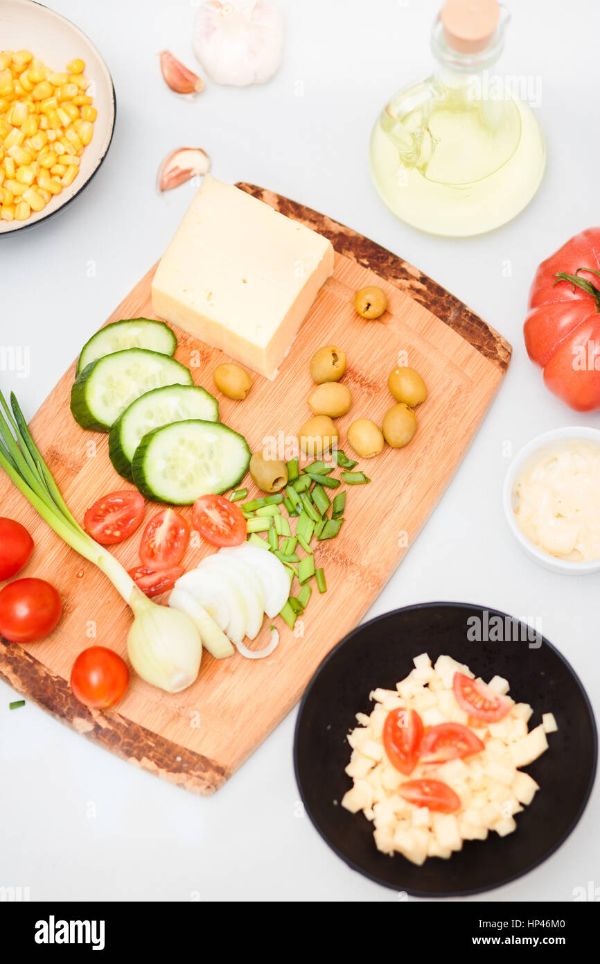 Preparing healthy snacks with fresh cheese and vegetables Stock Photo