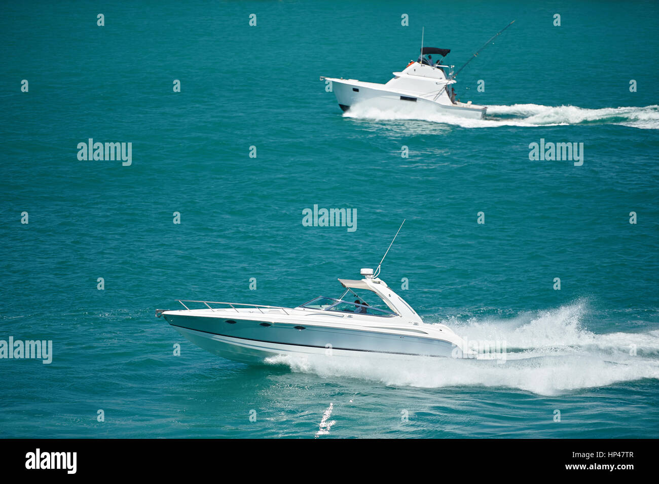 Private fishing boats moving in blue water. Two motor boats at sea Stock Photo