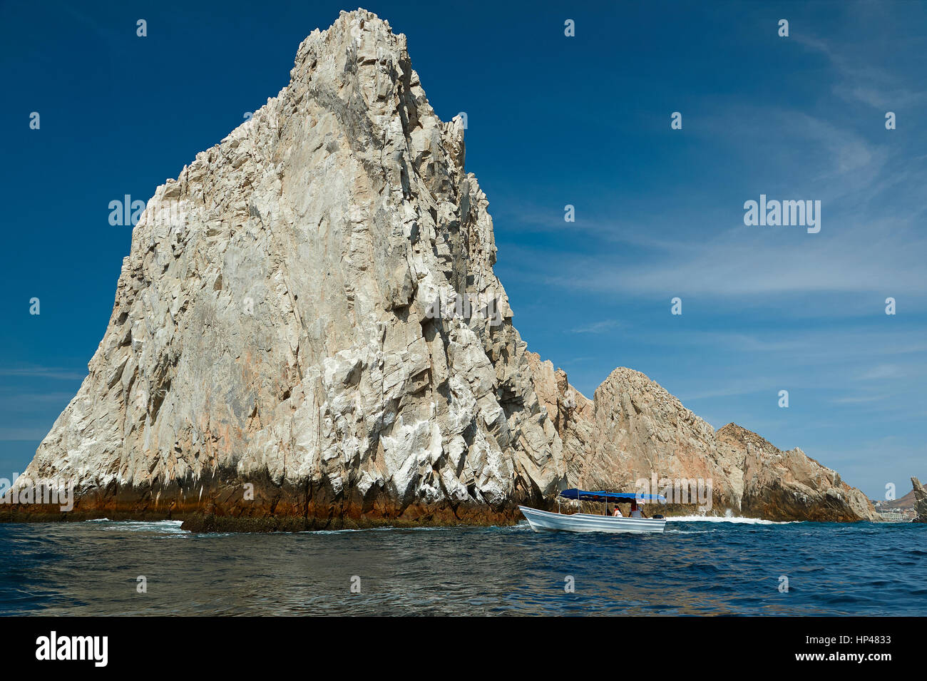 Boat close to big rock in Cabo San Lucas Mexico. Boat tour to huge rock at sea Stock Photo
