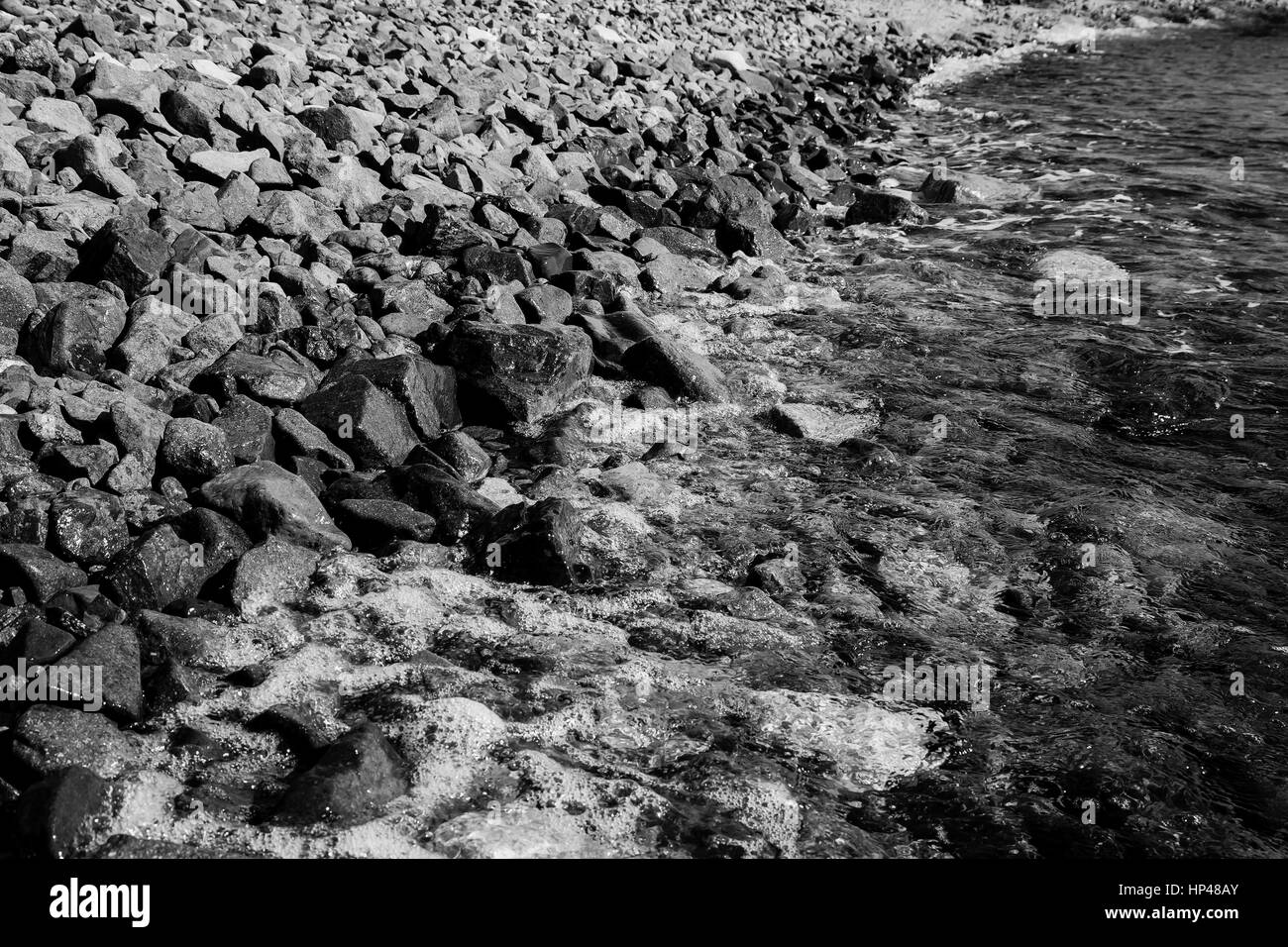 Wet shiny pebbles on beach Black and White Stock Photos & Images - Alamy