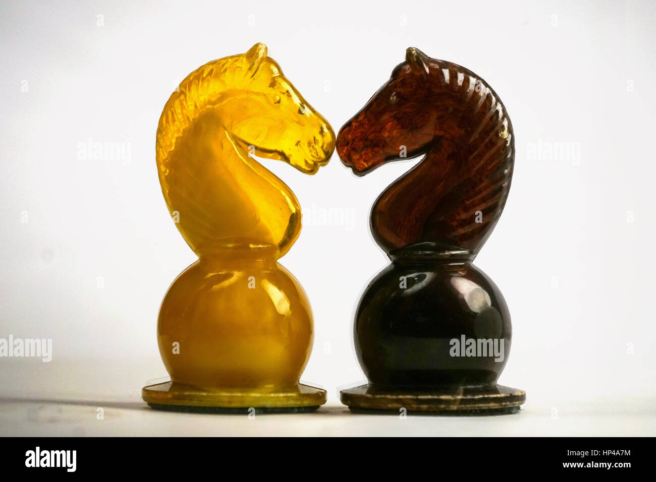 Horse knight chess pieces facing and confronting each other Stock Photo