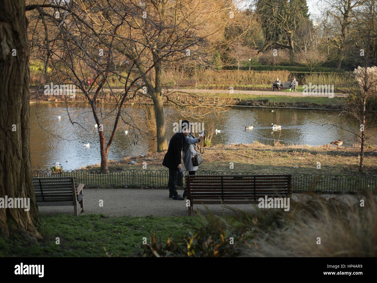People enjoy a spell of warm weather in Regent's Park, London, as a
