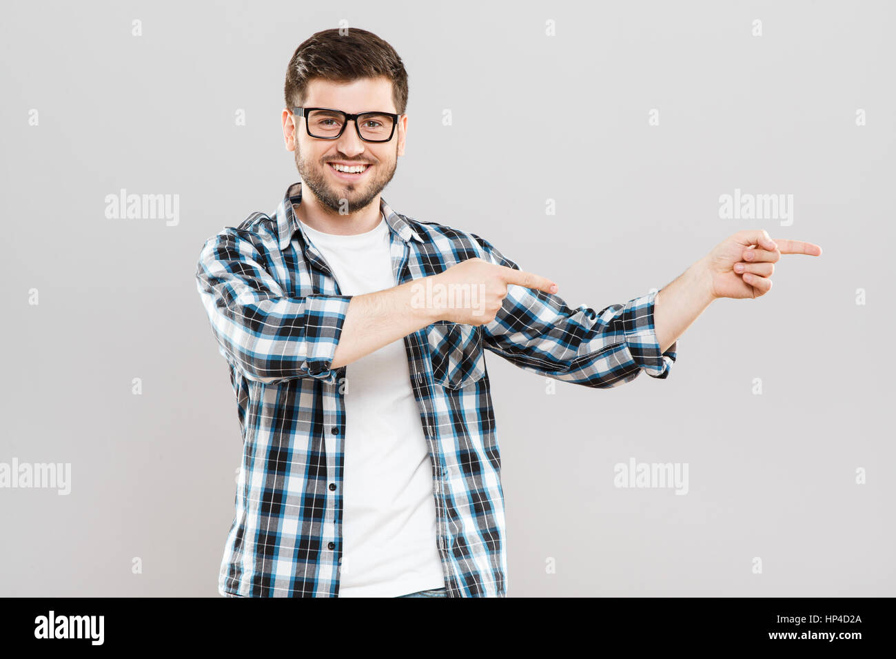 Young man pointing aside Stock Photo