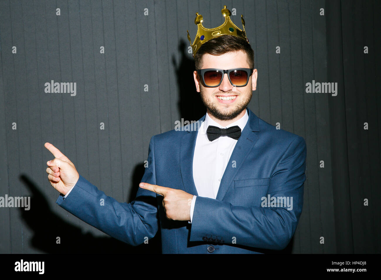 Man in crown pointing aside Stock Photo
