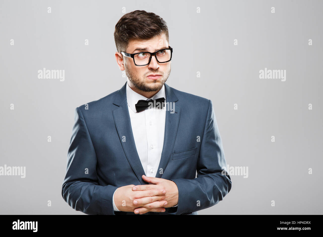 Young man looking with suspicion Stock Photo - Alamy