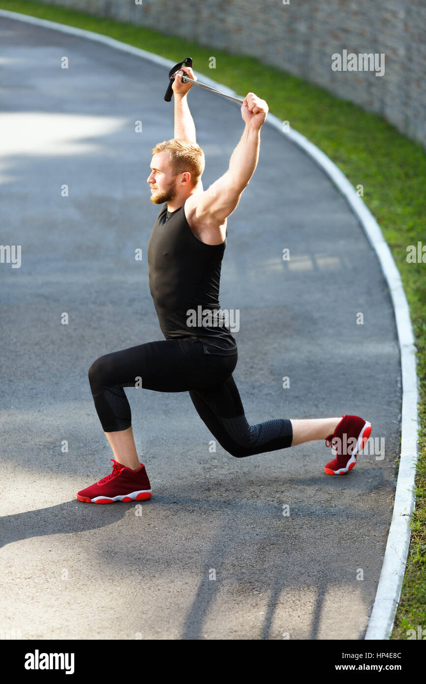 Man lunging with expander Stock Photo Alamy