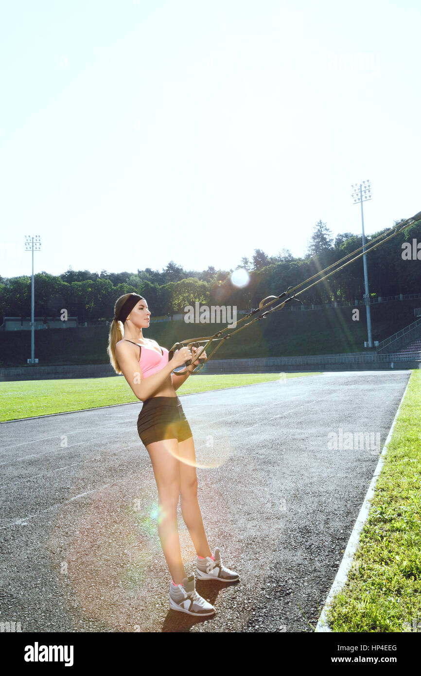 Woman with training loop on stadium Stock Photo - Alamy