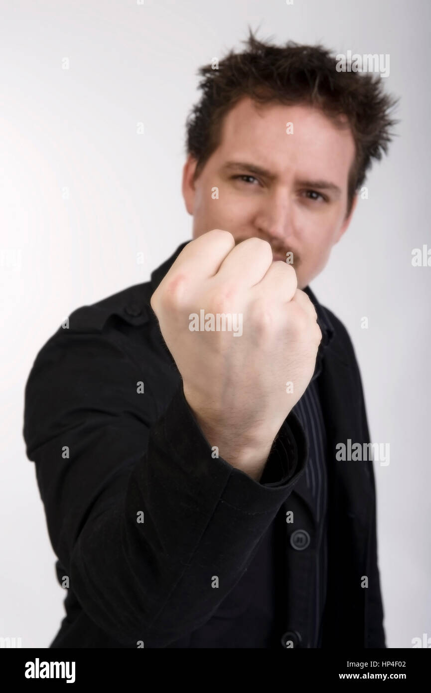 Model released , Junger Mann mit geballter Faust - young man with clenched fist Stock Photo