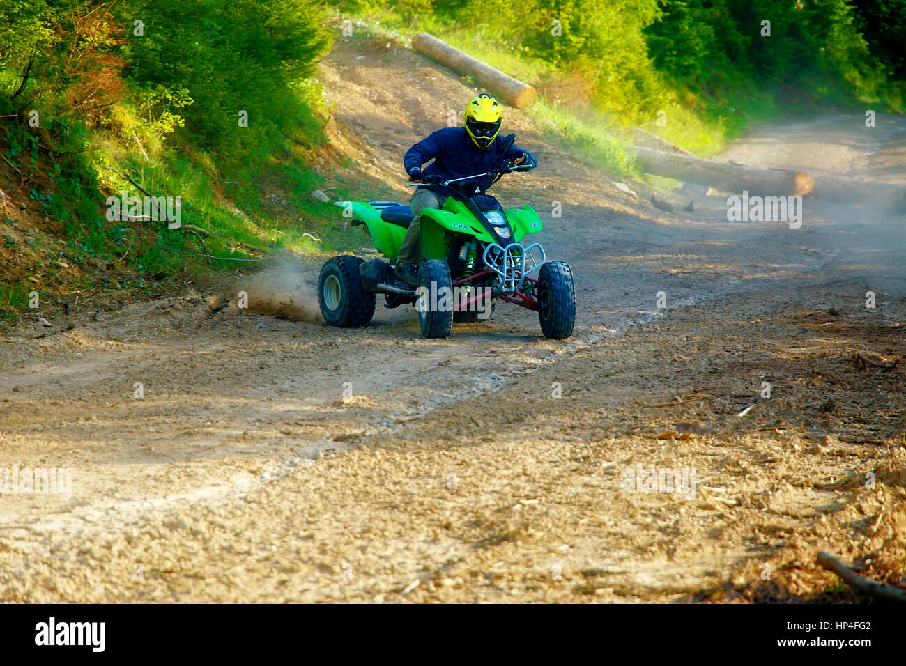 Quad Racing Yellow racer with yellow helmet on green quad enjoying his ride outdoors Stock ...