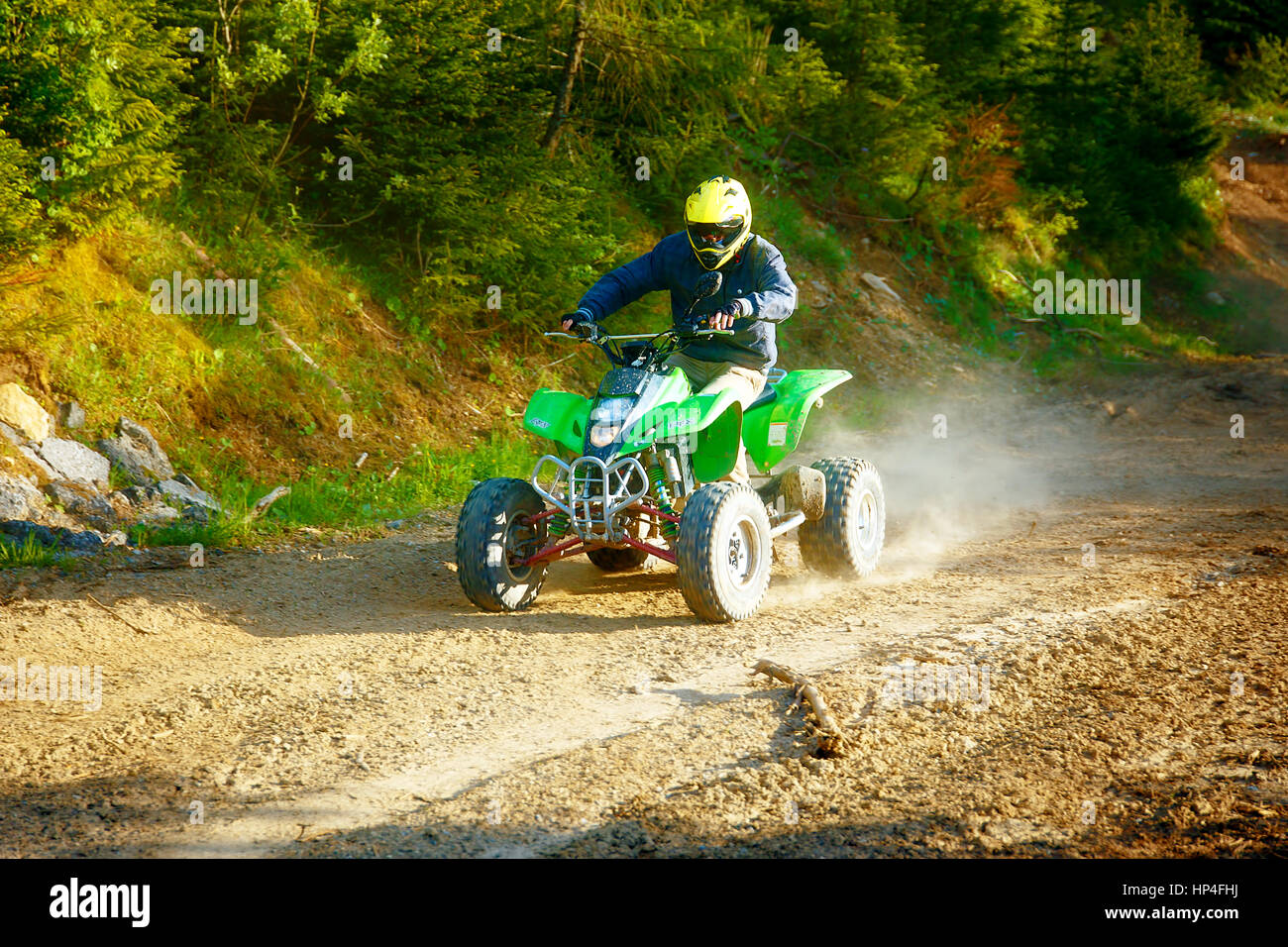 Quad Racing Yellow racer with yellow helmet on green quad enjoying his ride outdoors Stock ...