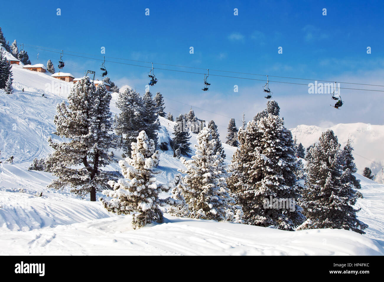 Chair ski lifts with skiers over blue sky in Mayrhofen, Austria Stock ...