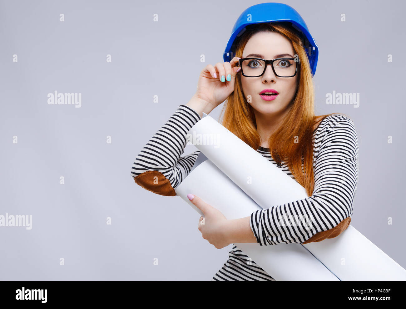 Girl in helmet with sheet of paper Stock Photo - Alamy