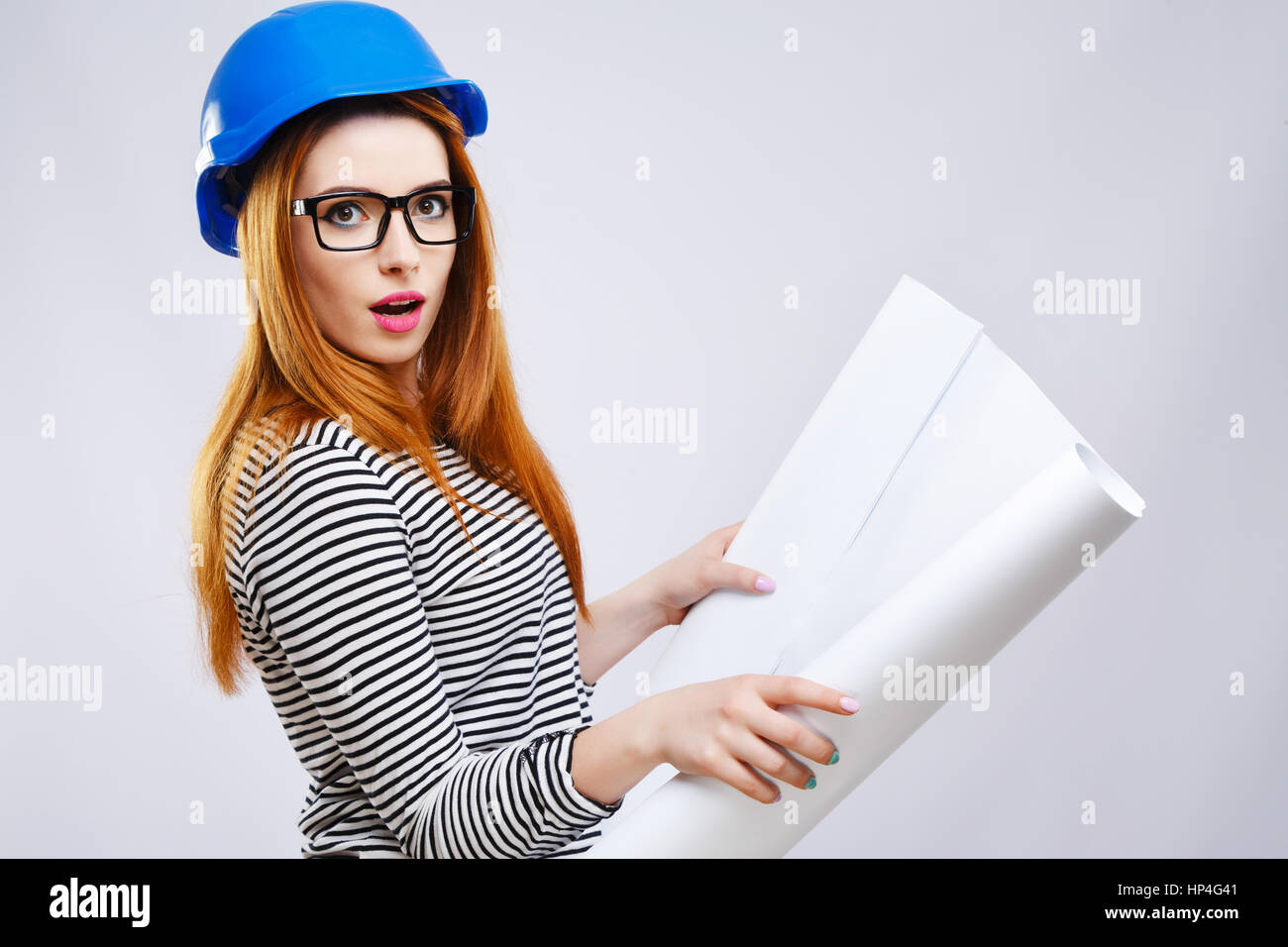 Girl in blue helmet with sheet of paper Stock Photo - Alamy