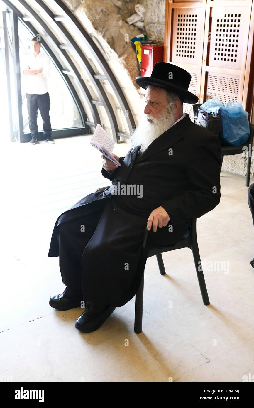 ultra-orthodox jewish man reading a book in a temple at western wall. old city, jerusalem, israel Stock Photo